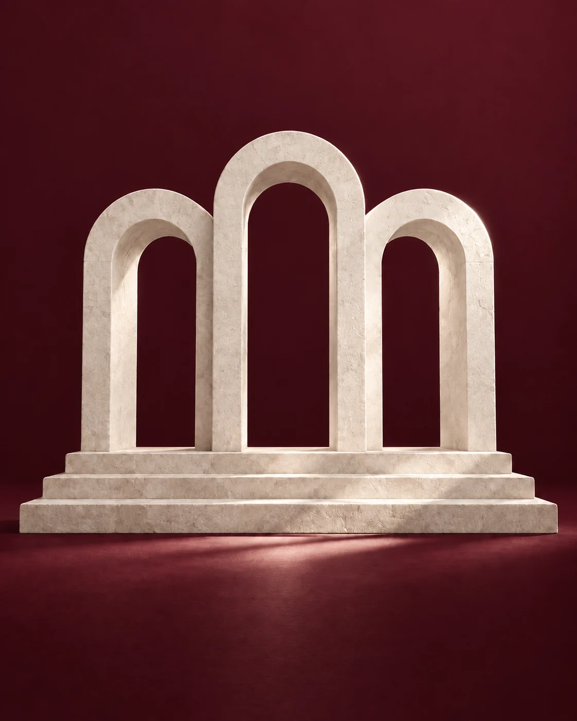 Three ivory limestone arches on broad stone steps against a deep burgundy backdrop.